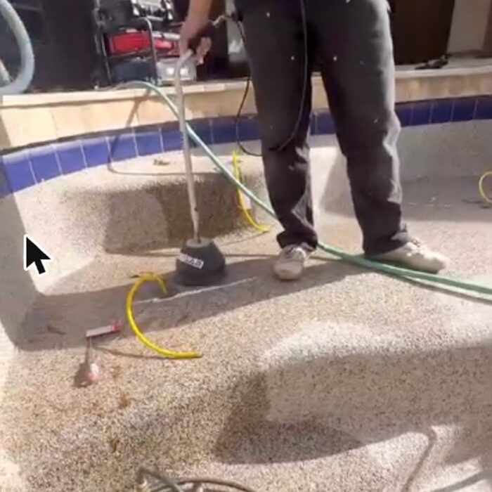 Pressure testing rig and hoses set up in a drained Chandler play pool