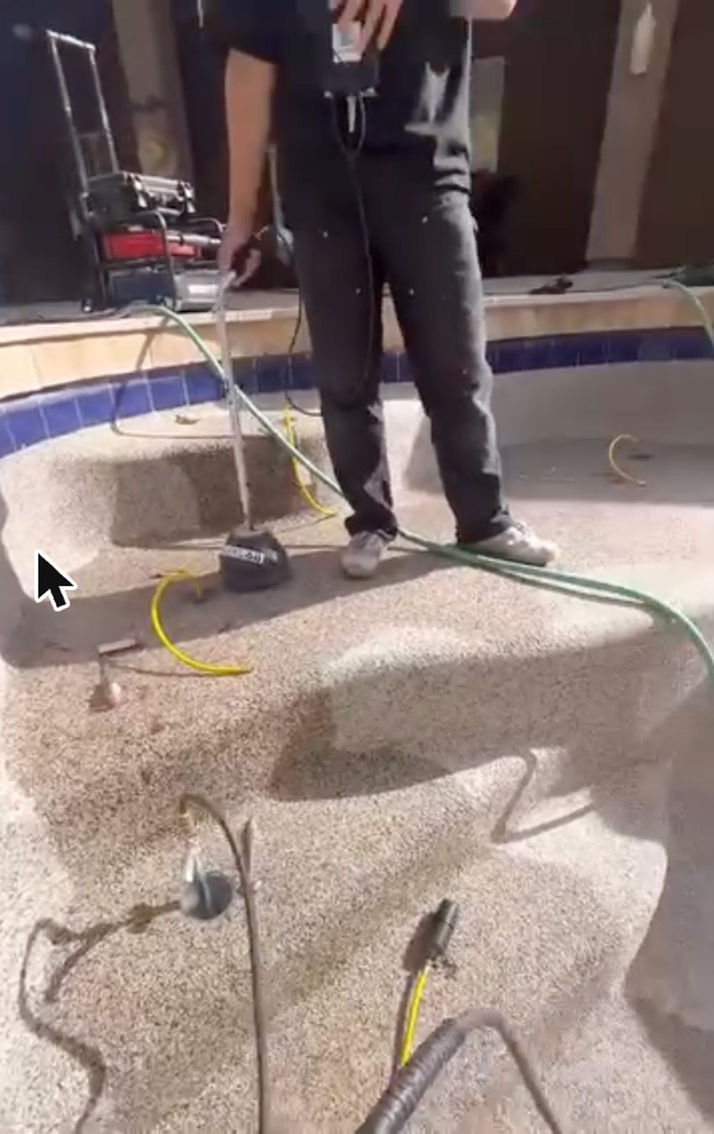 Technician performing pool leak detection in Chandler on a drained play pool with pressure testing equipment