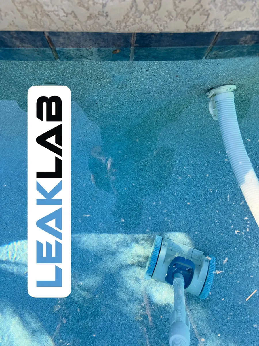 Structural crack visible underwater on a pebble finish pool wall in Scottsdale, AZ